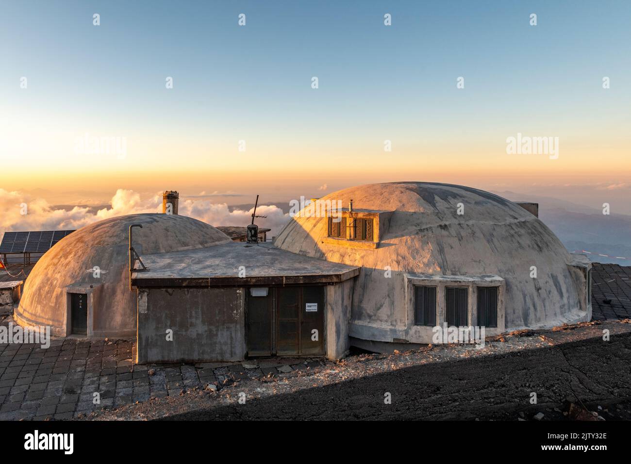 The volcanological observatory of Pizzi Deneri at 2800m on Mount Etna, Sicily, Italy, seen at sunset Stock Photo