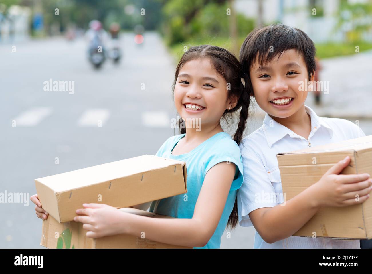 Children With Box Portrait of happy children holding cardboard boxes Stock Photo - Alamy