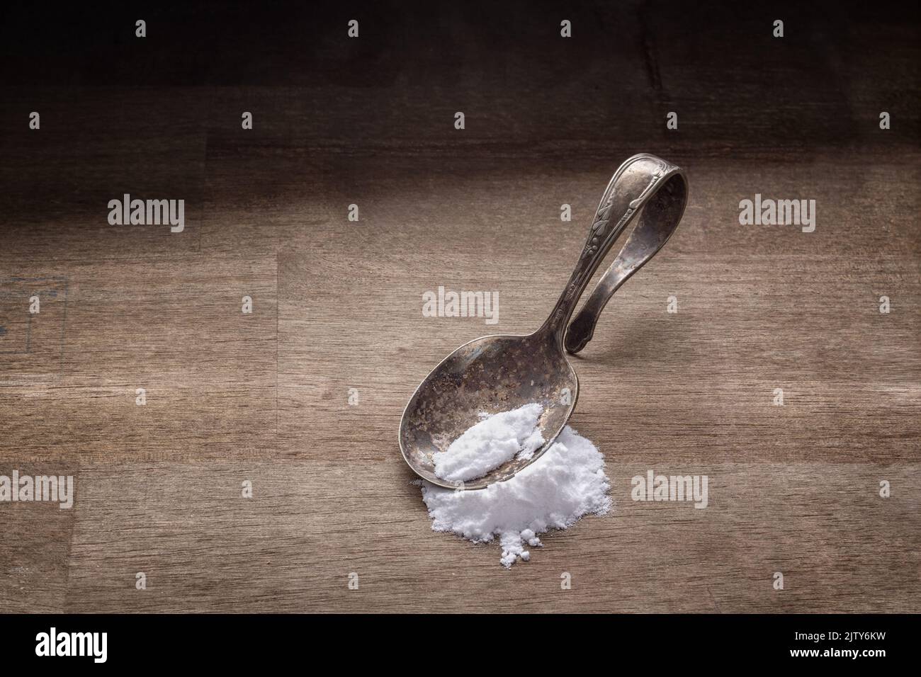 Drug addiction concept with spoon and white powder on wood Stock Photo