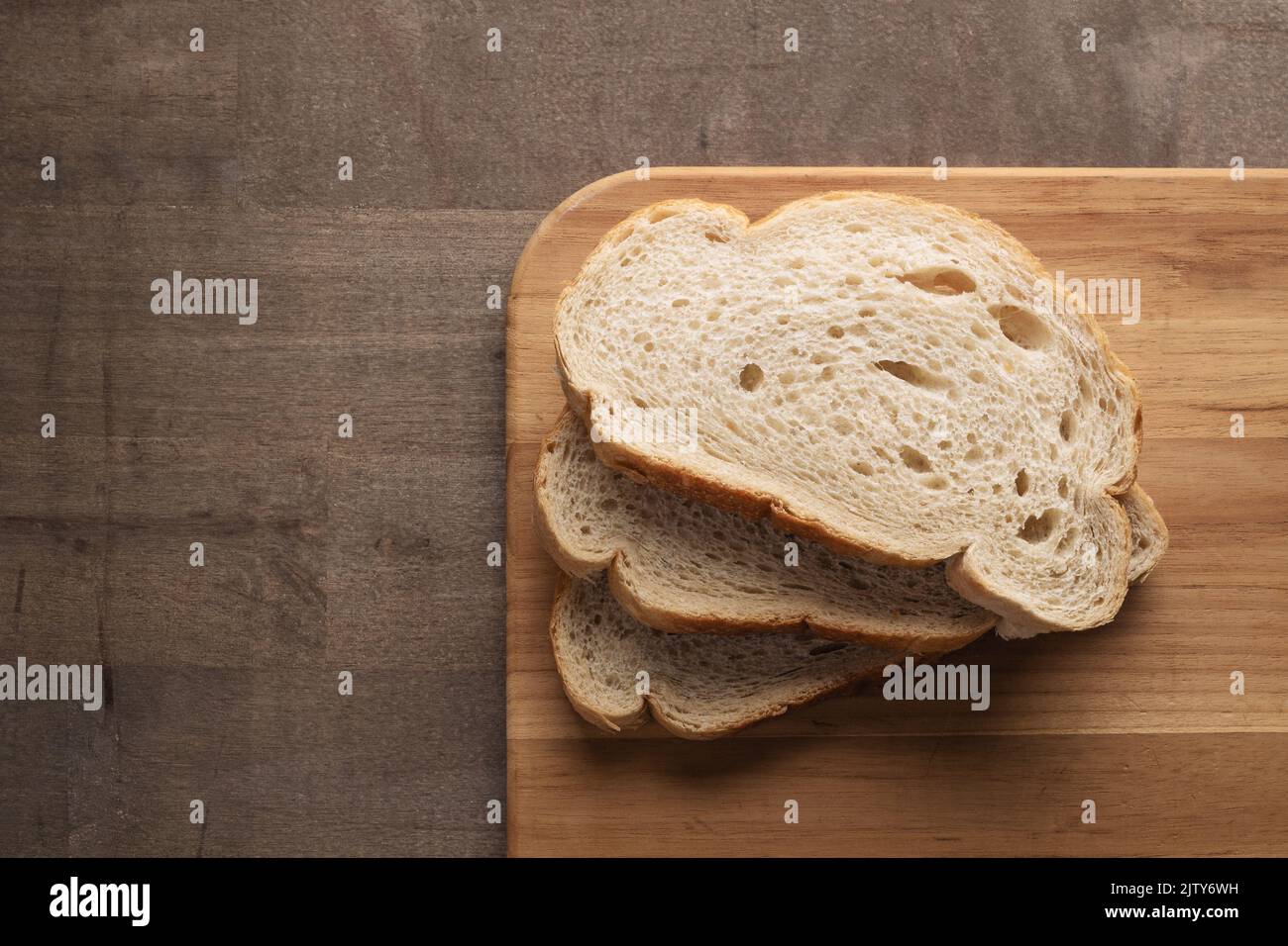 Sliced rye bread on cutting board with copy space Stock Photo