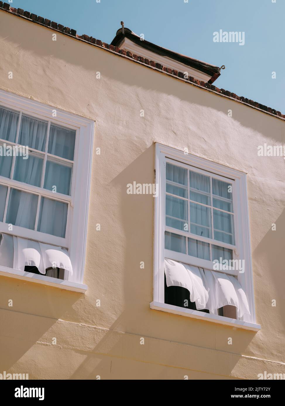 Open sash windows with net curtains blowing in the wind - summer window ...