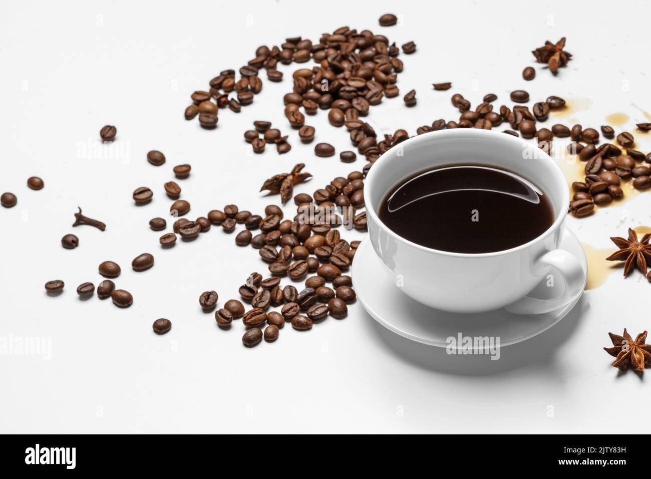 Coffee cup and beans on a white background Stock Photo - Alamy