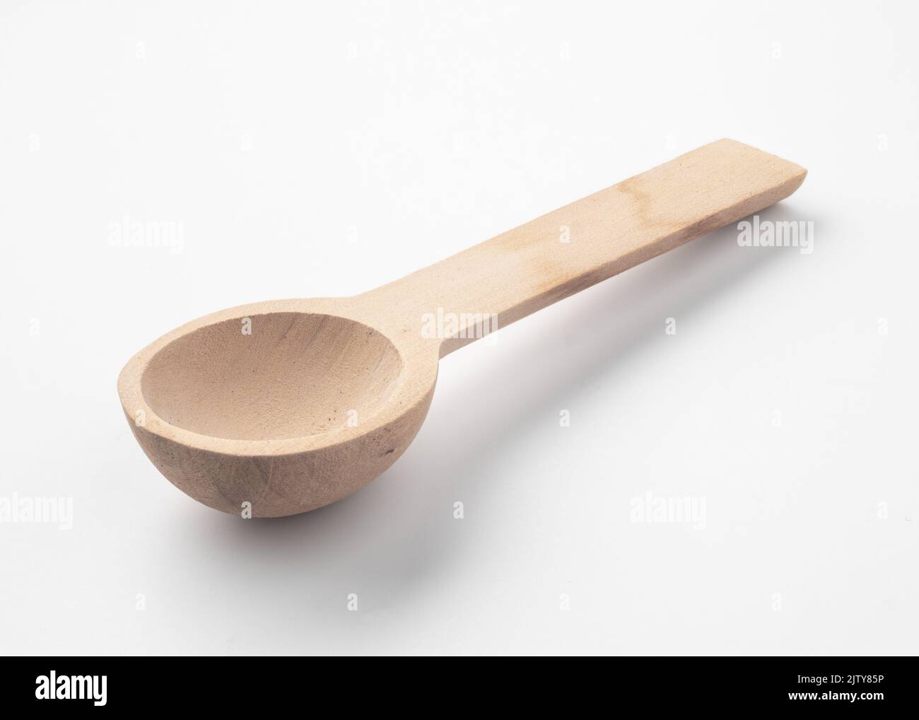 Traditional wooden spoon on white surface Stock Photo