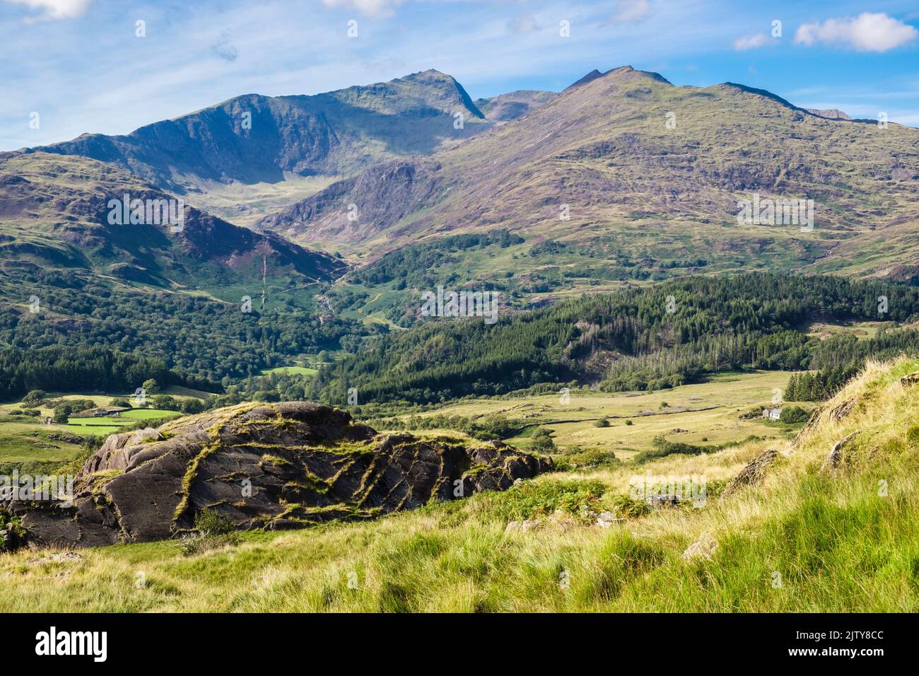 Mount Snowdon summit peak across Nant Gwynant valley from lower slopes of Cnicht in mountains of Snowdonia National Park. Beddgelert Gwynedd Wales UK Stock Photo