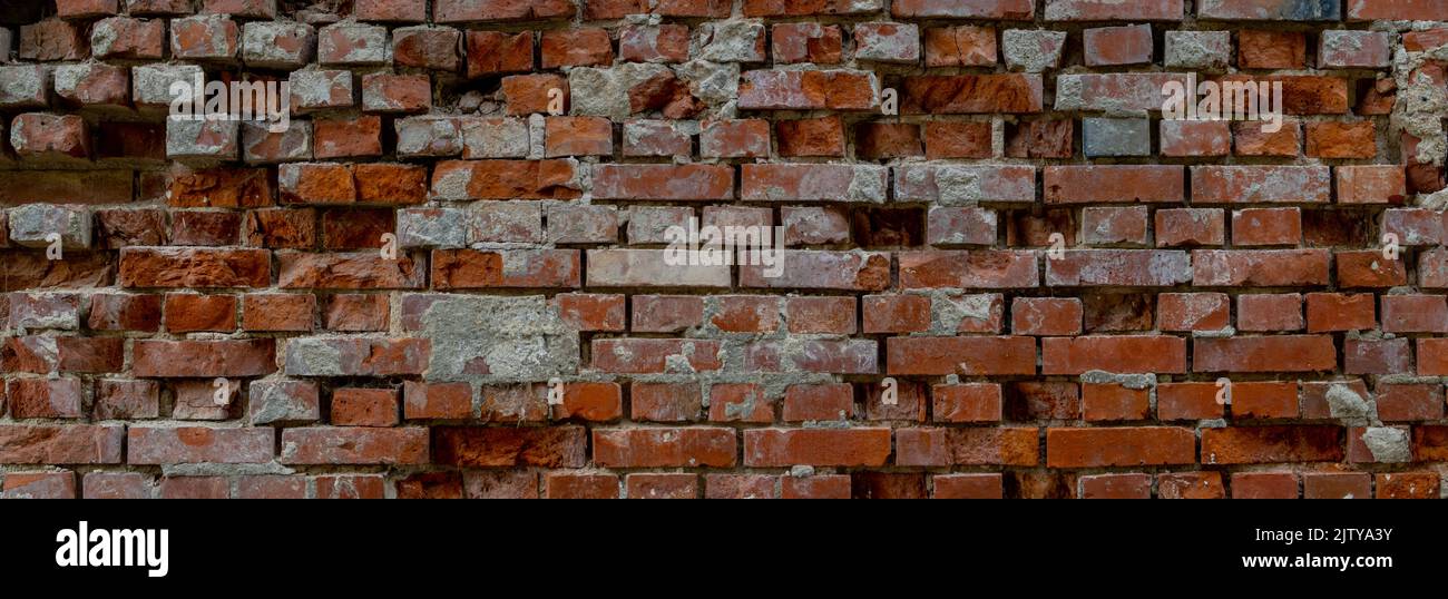 Panoramic old damaged red brick wall background with copy space Stock Photo