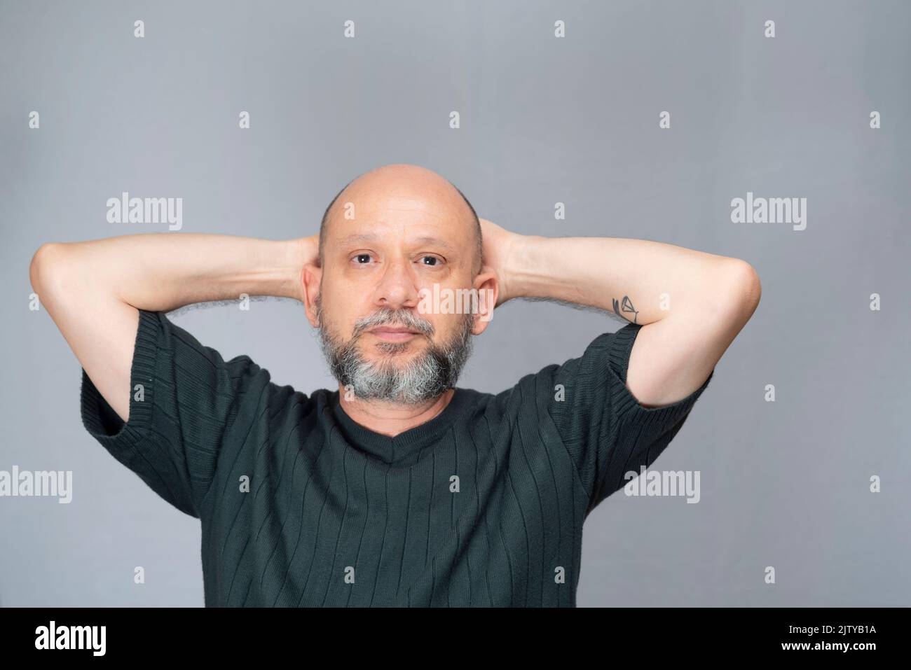 Portrait of mature man standing on white background. Serious bearded man. Formal style. Stock Photo