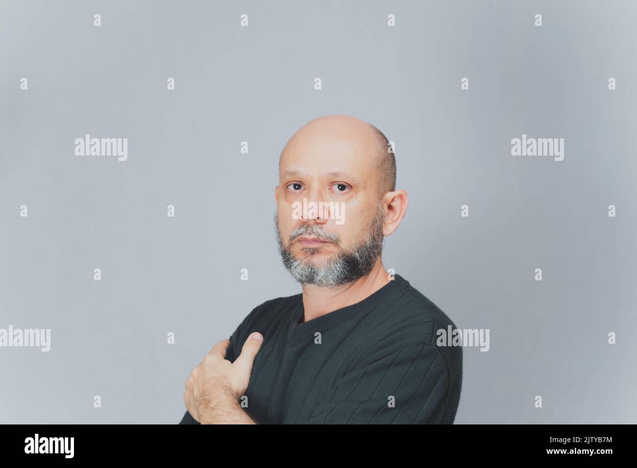 Portrait of mature man standing on white background. Serious bearded man. Formal style. Stock Photo