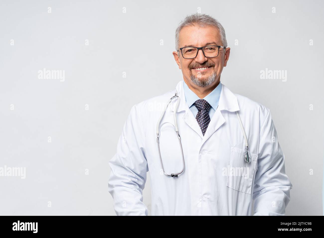 Horizontal Portrait of serious mature male doctor or therapist in white ...