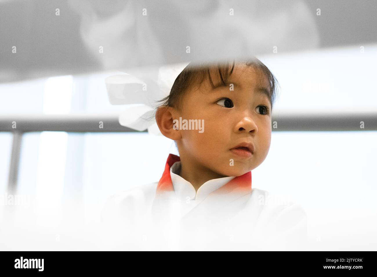 A toddler chef play pretend. Chef cook costume attire. Asian-Filipino girl. Stock Photo