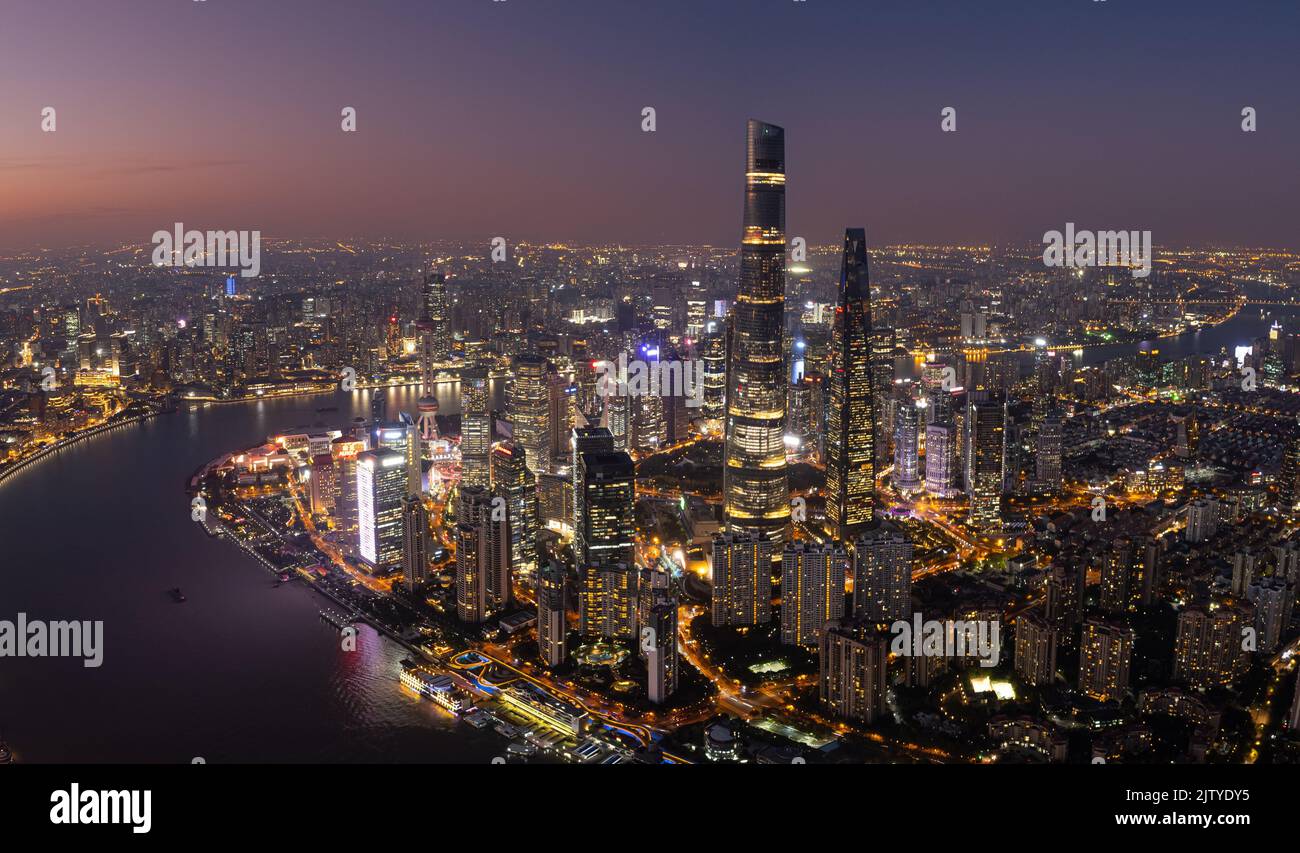 An aerial view of modern buildings illuminated at night in Shanghai ...