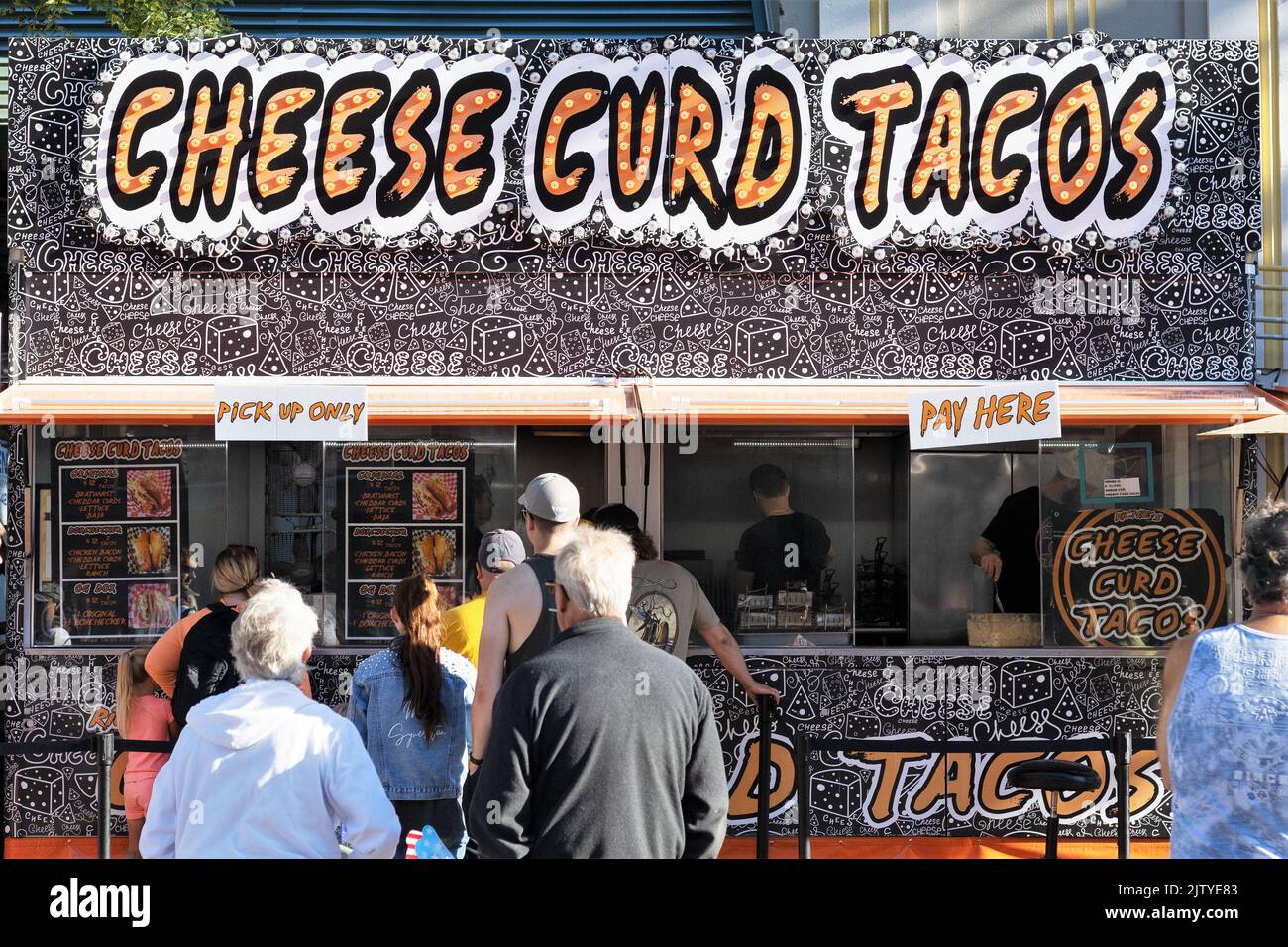 People lined up at the Cheese Curd Tacos food booth at the Minnesota