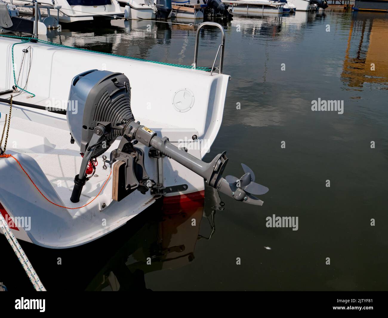 A view of the stern of a yacht with an outboard motor. Close up of