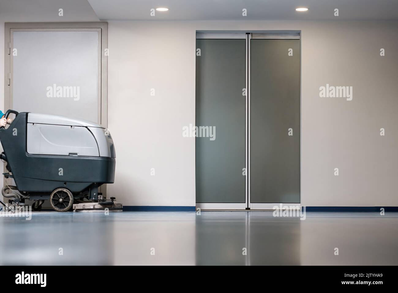 Professional floor cleaner machine that cleans the floors of an empty business center Stock Photo