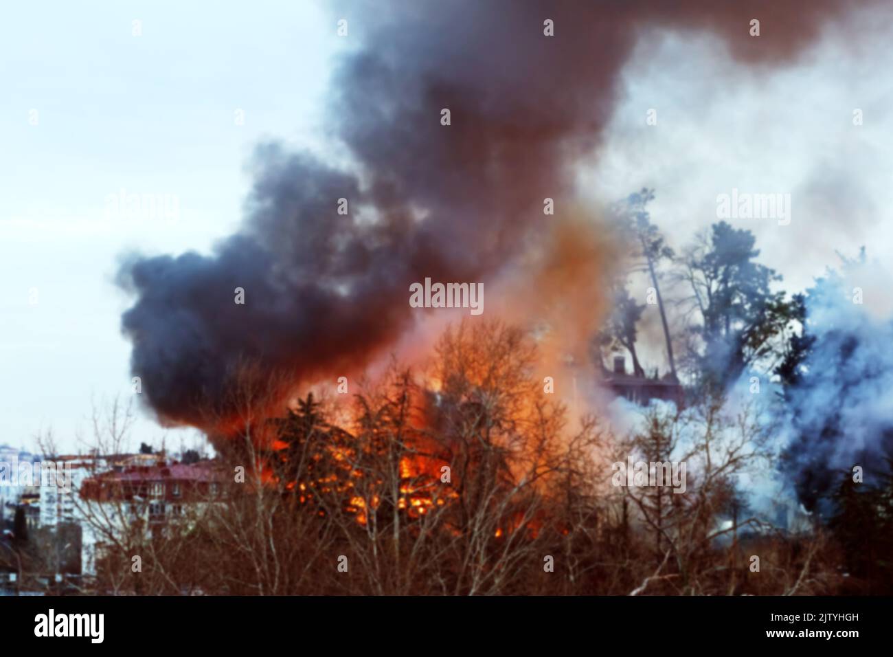 Strong house fire, a fire and black column of smoke. Blurred image Stock Photo