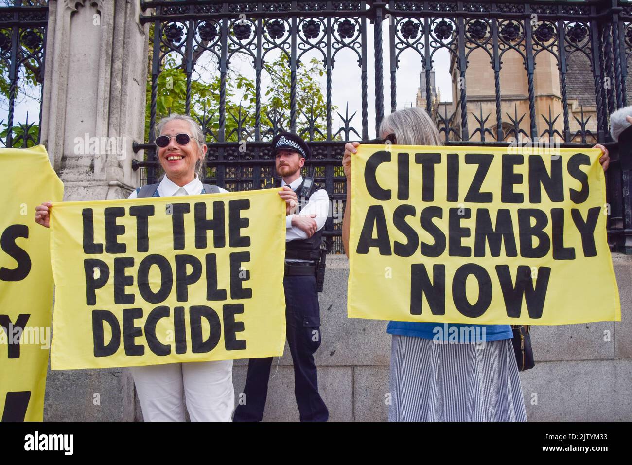London, UK. 2nd September 2022. Protesters hold banners. Extinction Rebellion protesters glued themselves inside the Parliament while others locked and glued themselves outside, demanding a Citizens' Assembly. Credit: Vuk Valcic/Alamy Live News Stock Photo
