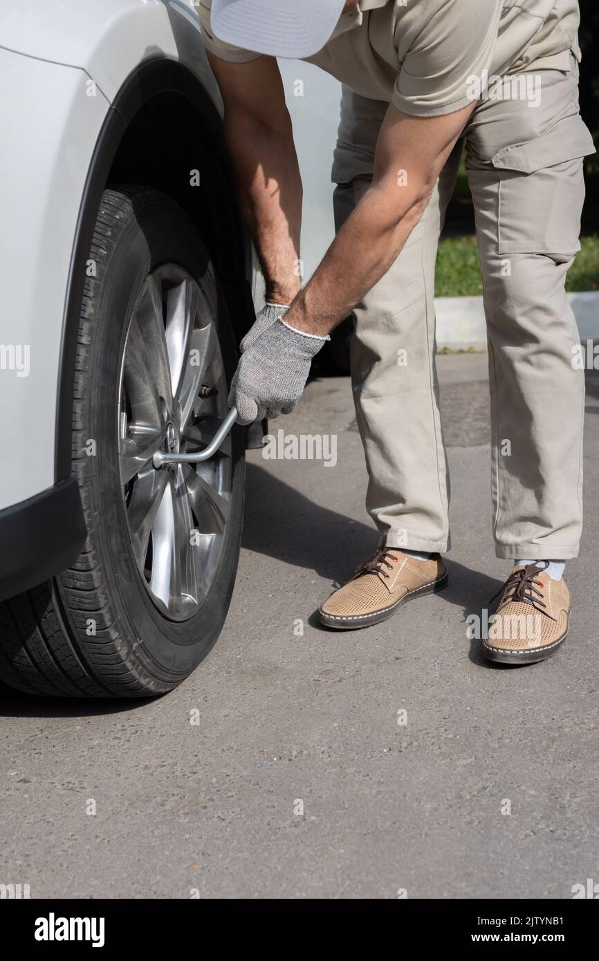 man tightening a bolt on a car wheel Stock Photo Alamy