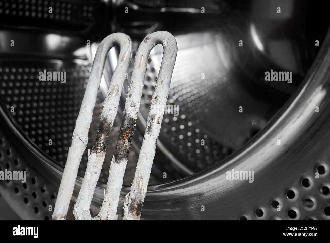 A burntout heating element of a washing machine against the background