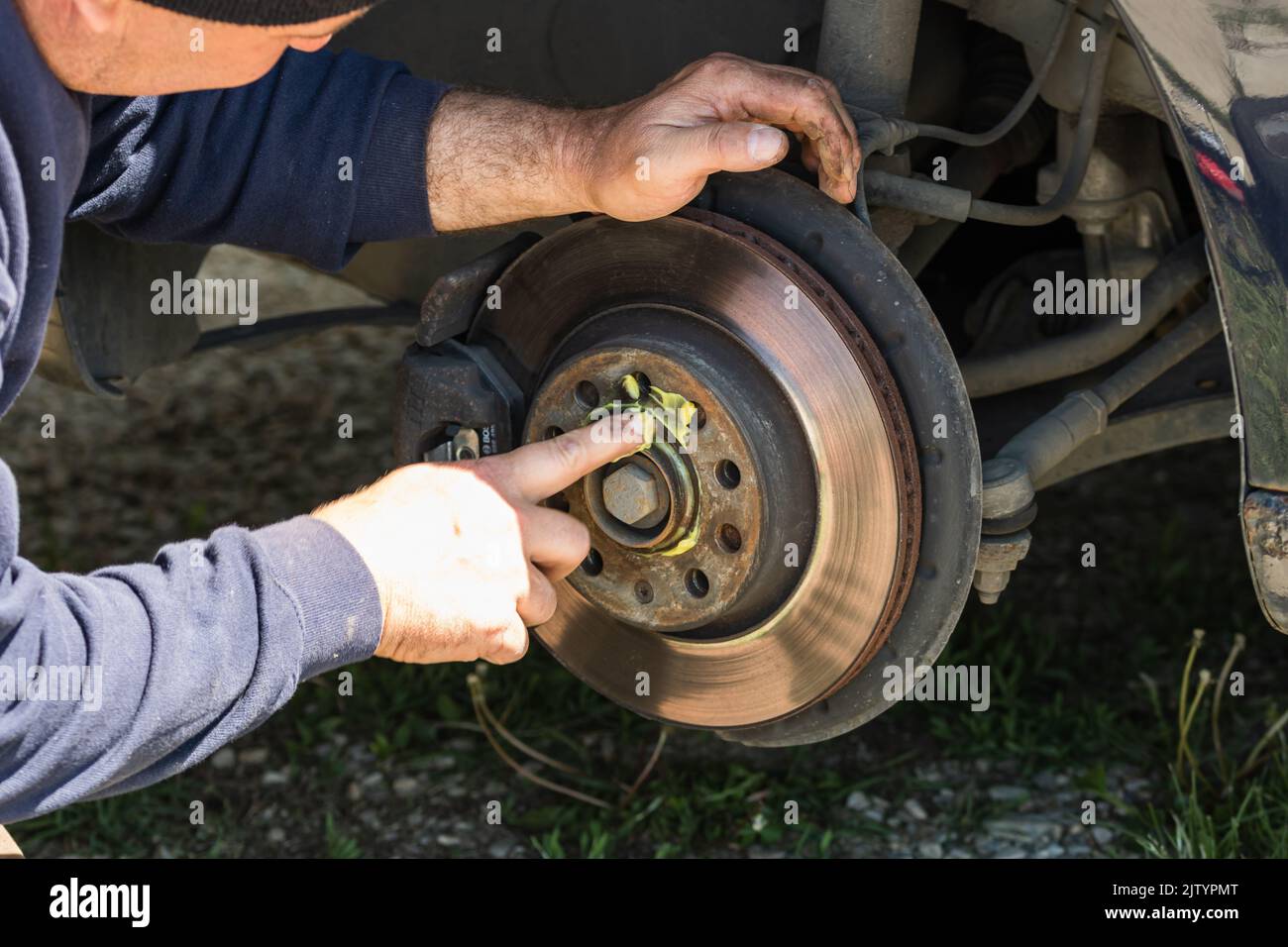 Mechanic Cleaning And Fixing The Brake System Of A Car In Romania ...