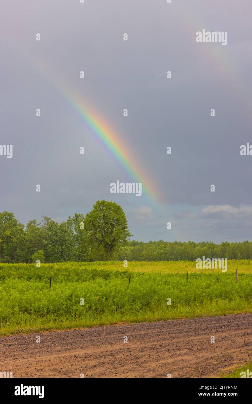 Rainbow over a northern Wisconsin field. Stock Photo