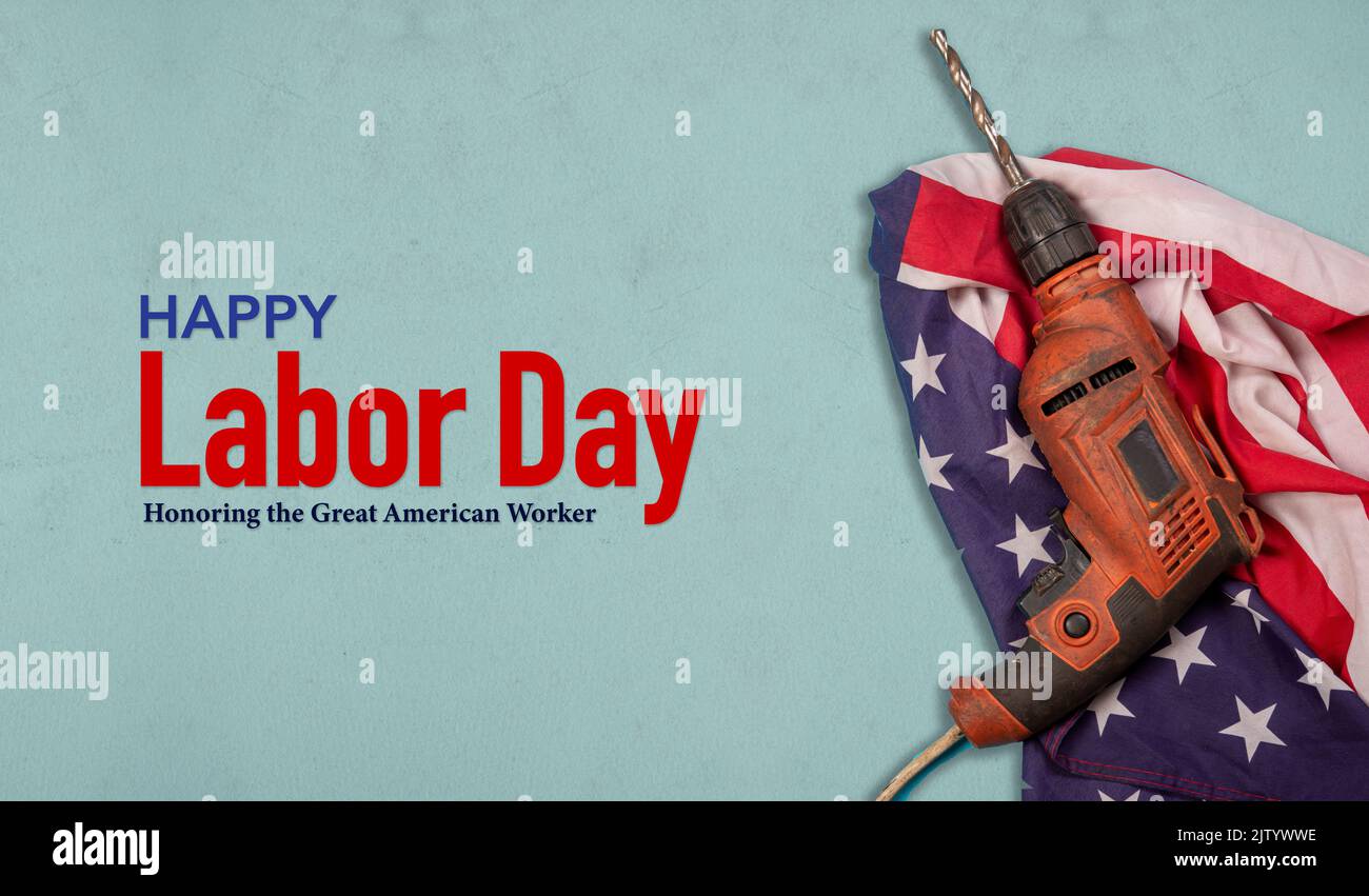 Happy Labor Day with drill machine on American flag - banner for great worker. Stock Photo