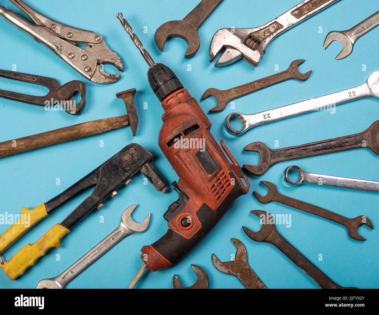 Drill machine with hardware tools around creating labor day theme. Stock Photo