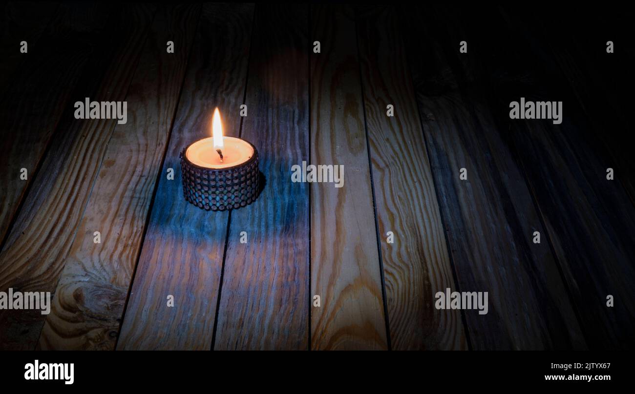 Candle light burning on wooden table memorial theme banner. Stock Photo