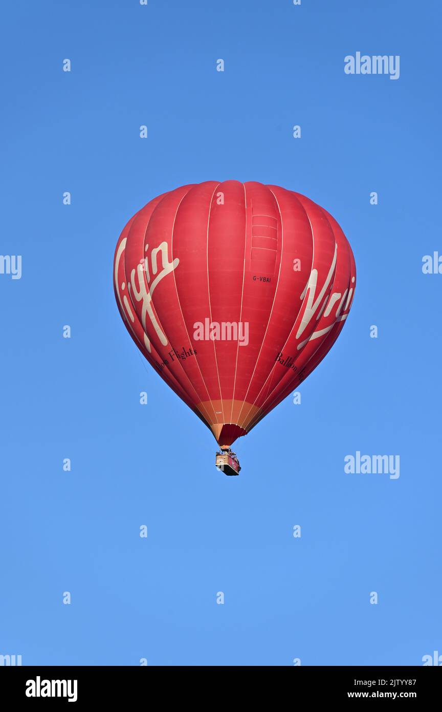 A Cameron A-400 balloon operated by Virgin Days Out flies over the north Oxfordshire village of Hook Norton. Stock Photo
