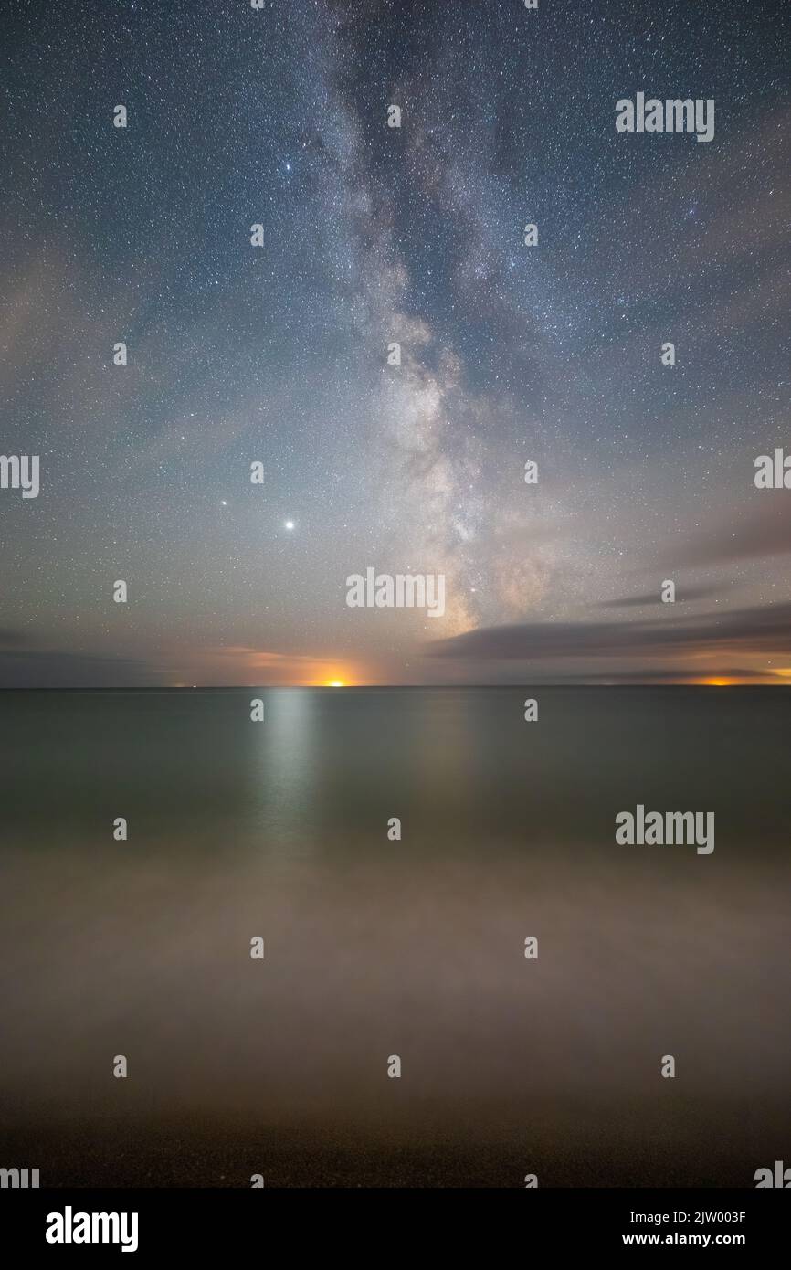 The Milky Way over the ocean at Eype's Mouth, Bridport, Jurassic Coast, Dorset, England, UK Stock Photo