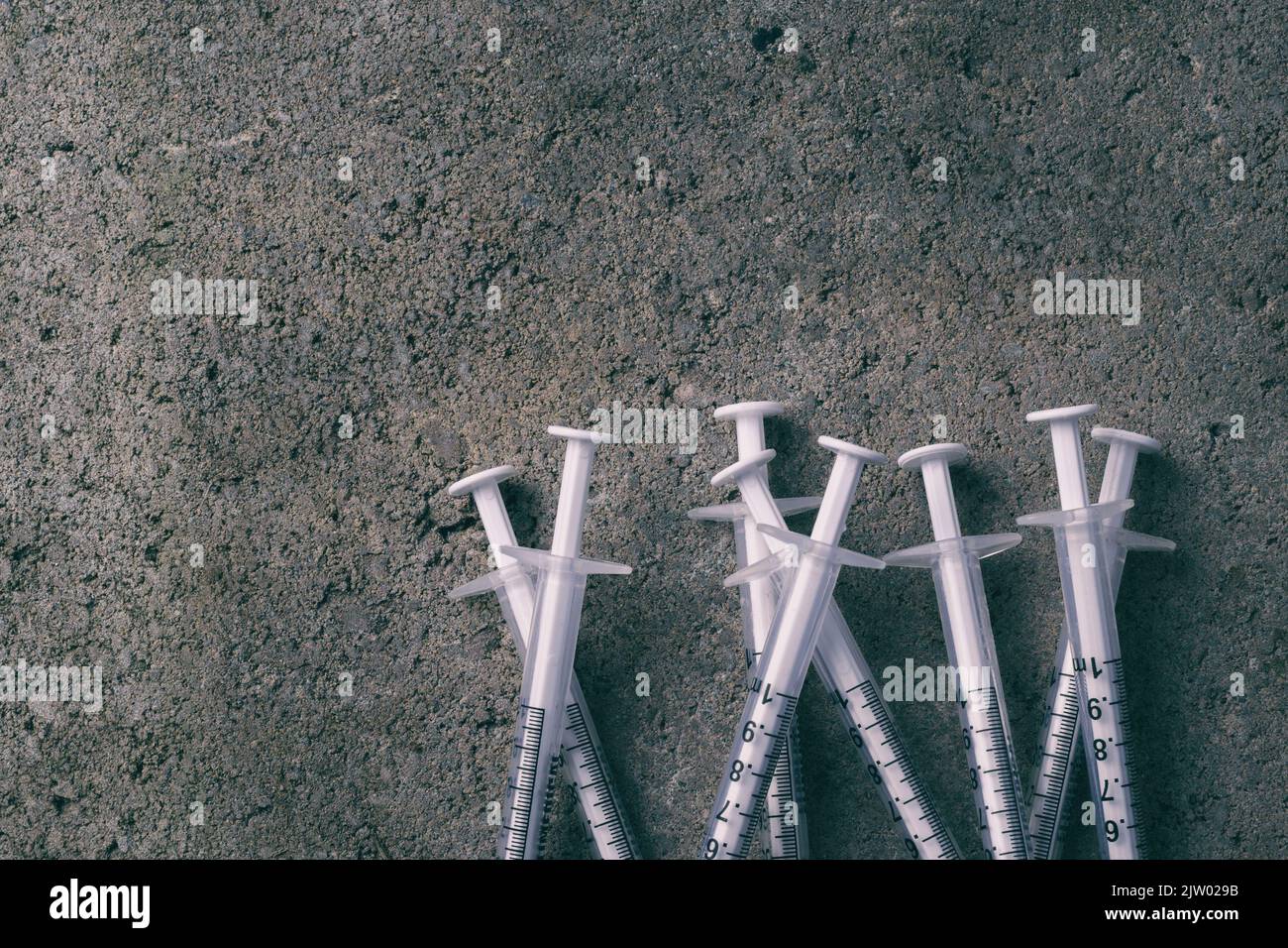 Empty syringes on concrete with copy space Stock Photo