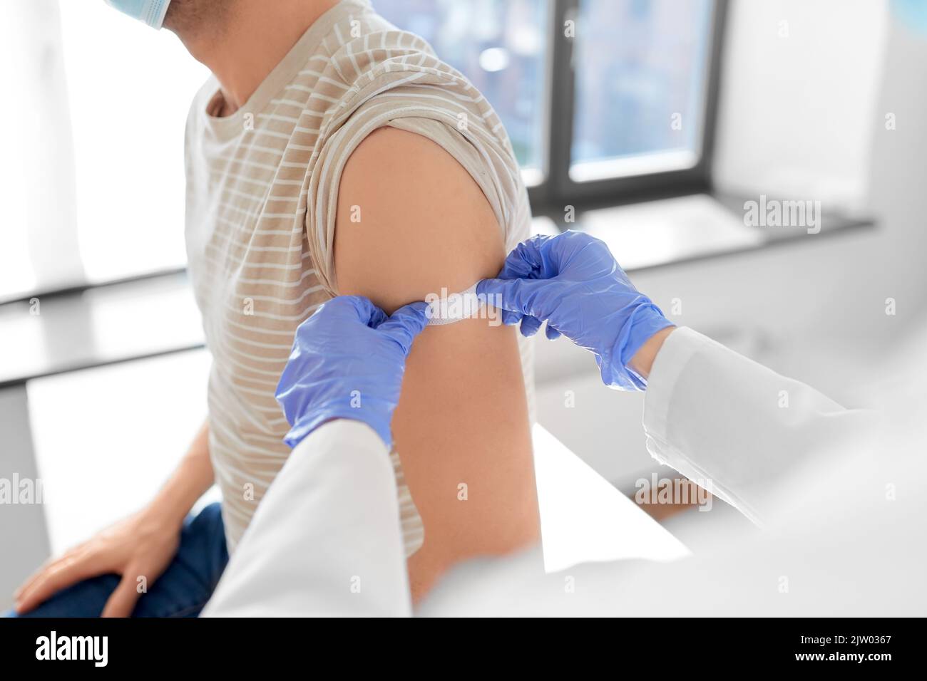 Female doctor attaching patch hi-res stock photography and images - Alamy