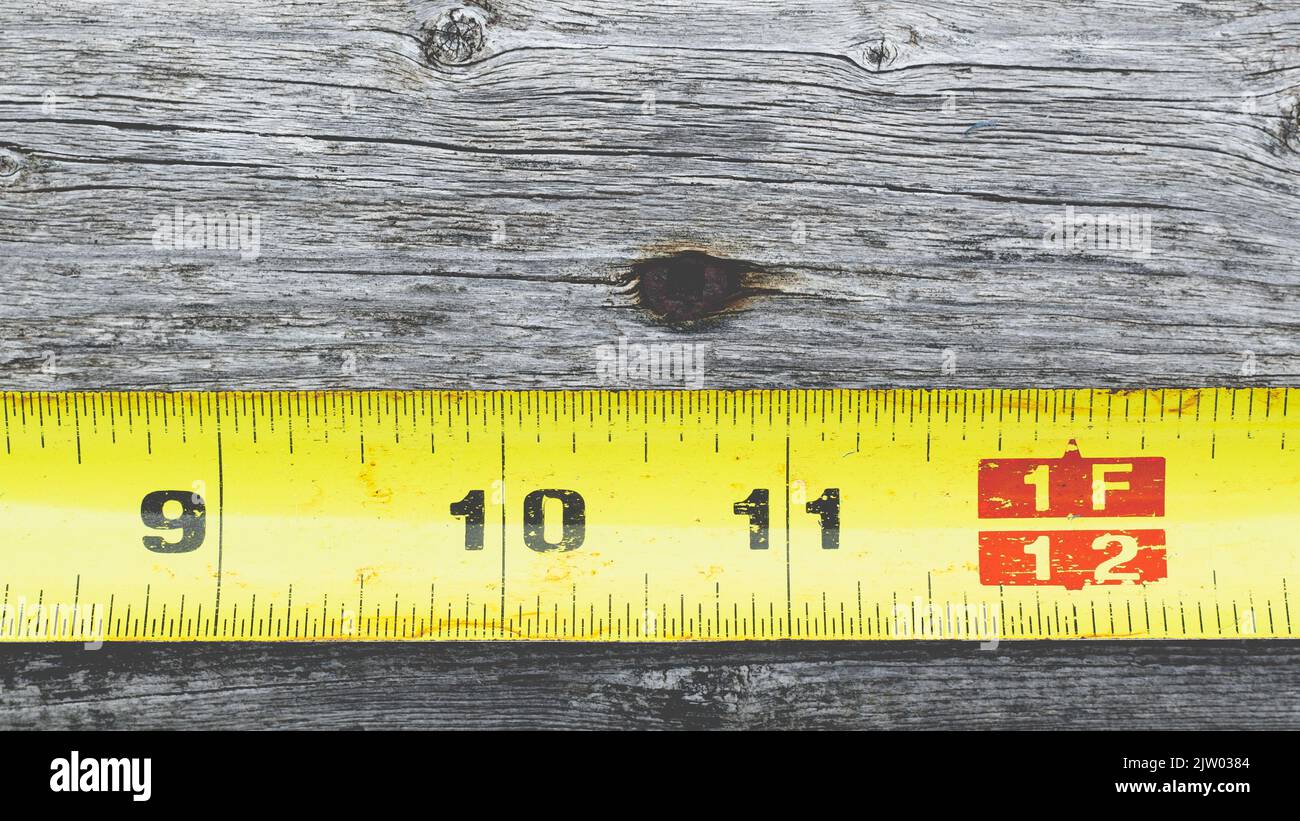 Measuring tape on wood detail with copy space Stock Photo