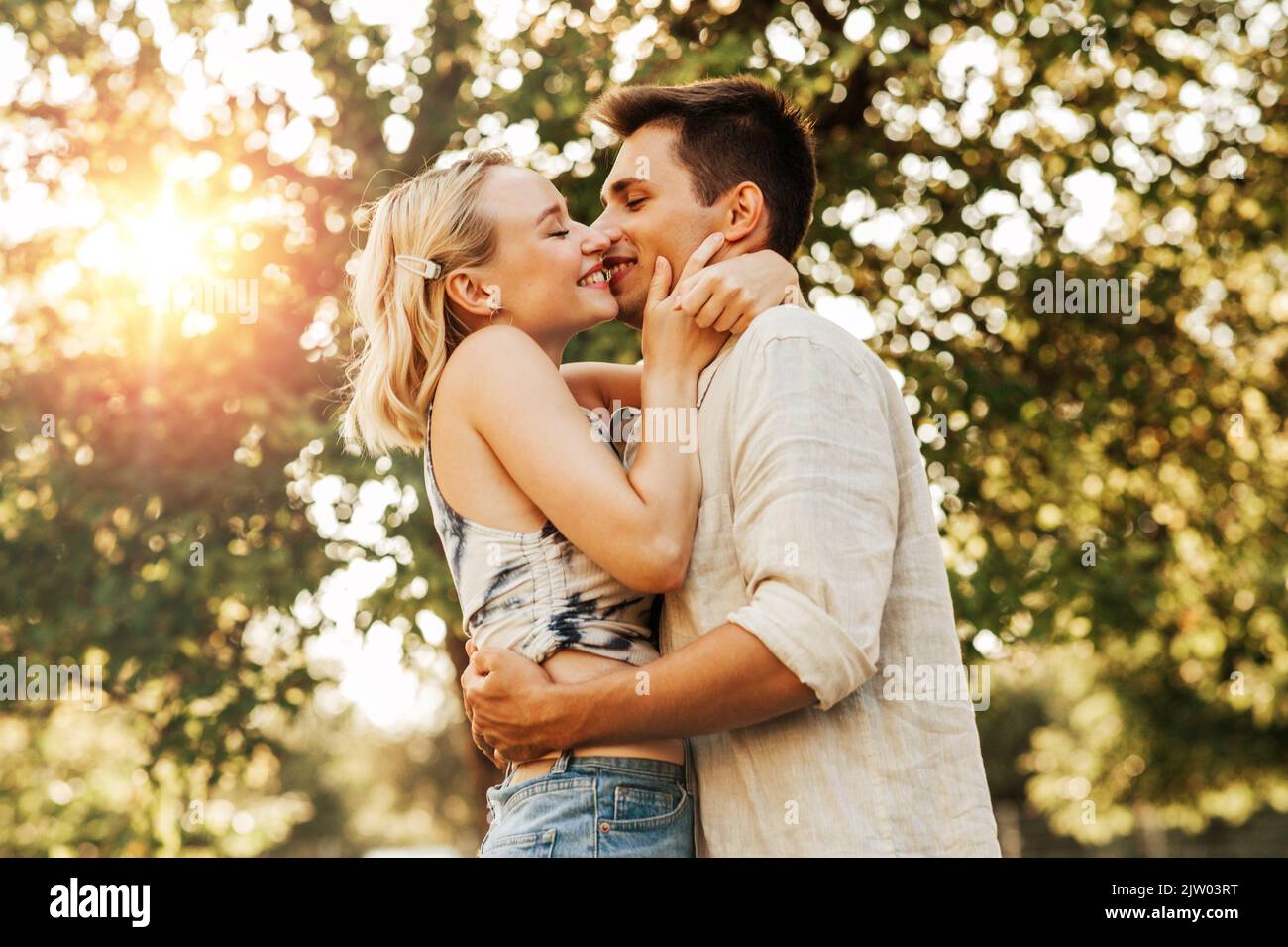 happy young couple kissing and hugging outdoors Stock Photo
