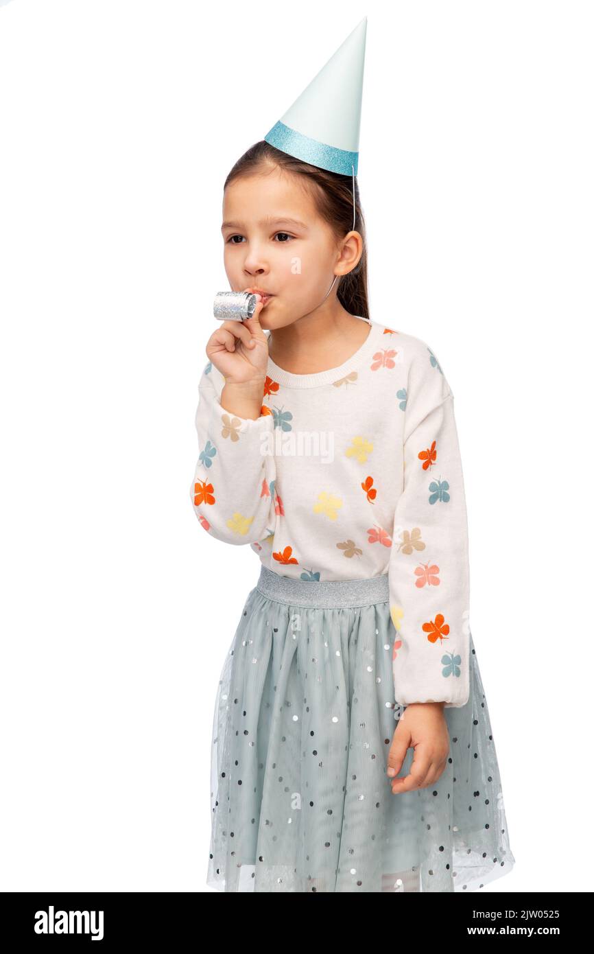 smiling girl in birthday party hat with blower Stock Photo - Alamy
