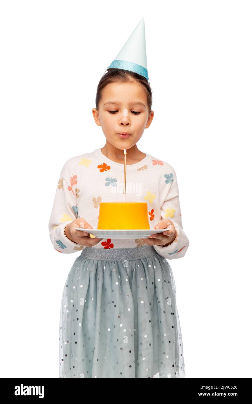girl with birthday cake blowing to candle Stock Photo Alamy