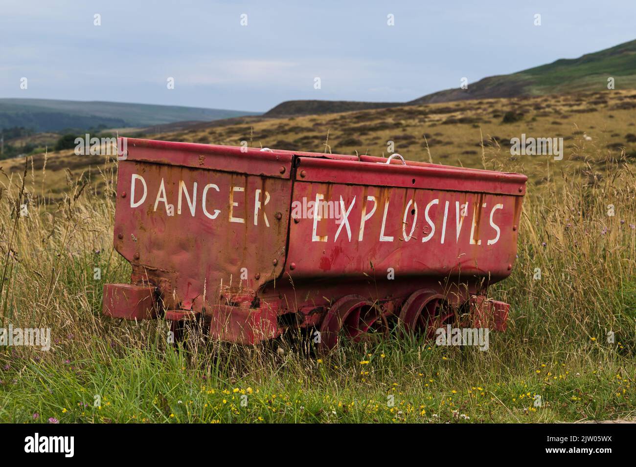 Explosivies wagon abandonded in the grass at The Big Pit Heritage Sight, Bleanavon, Wales. Taken 28th July 2022. Stock Photo