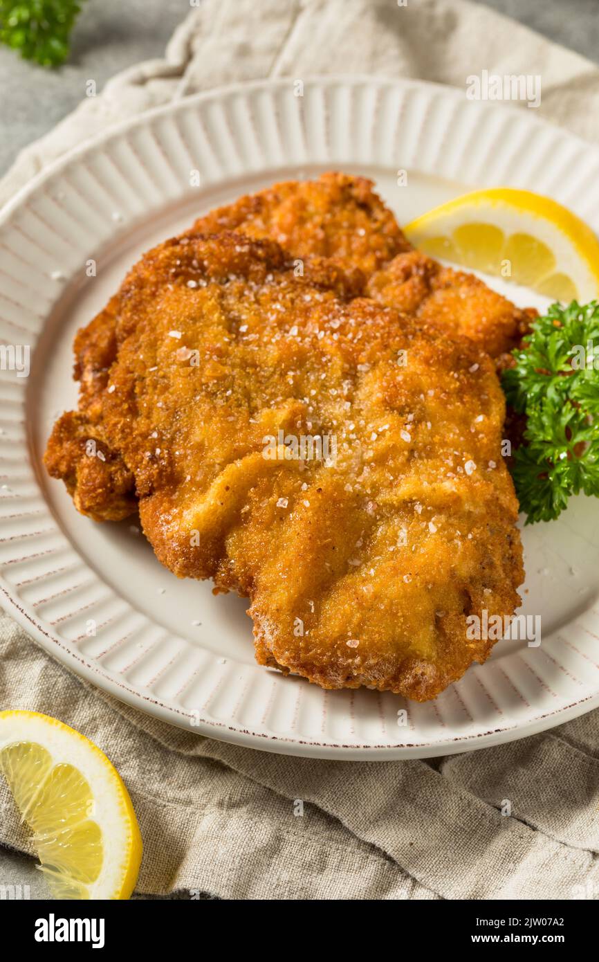 Homemade Deep Fried German Pork Schnitzel with Salt and Lemon Stock