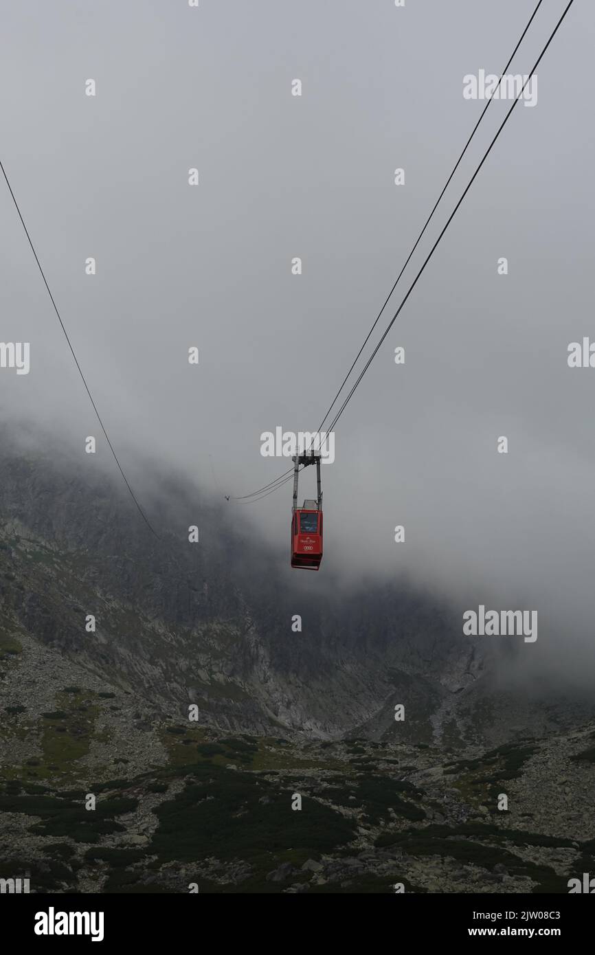 Cable car disappearing into the clouds on its journey to Lomnicky Stit, High Tatras Slovakia, Europe Stock Photo