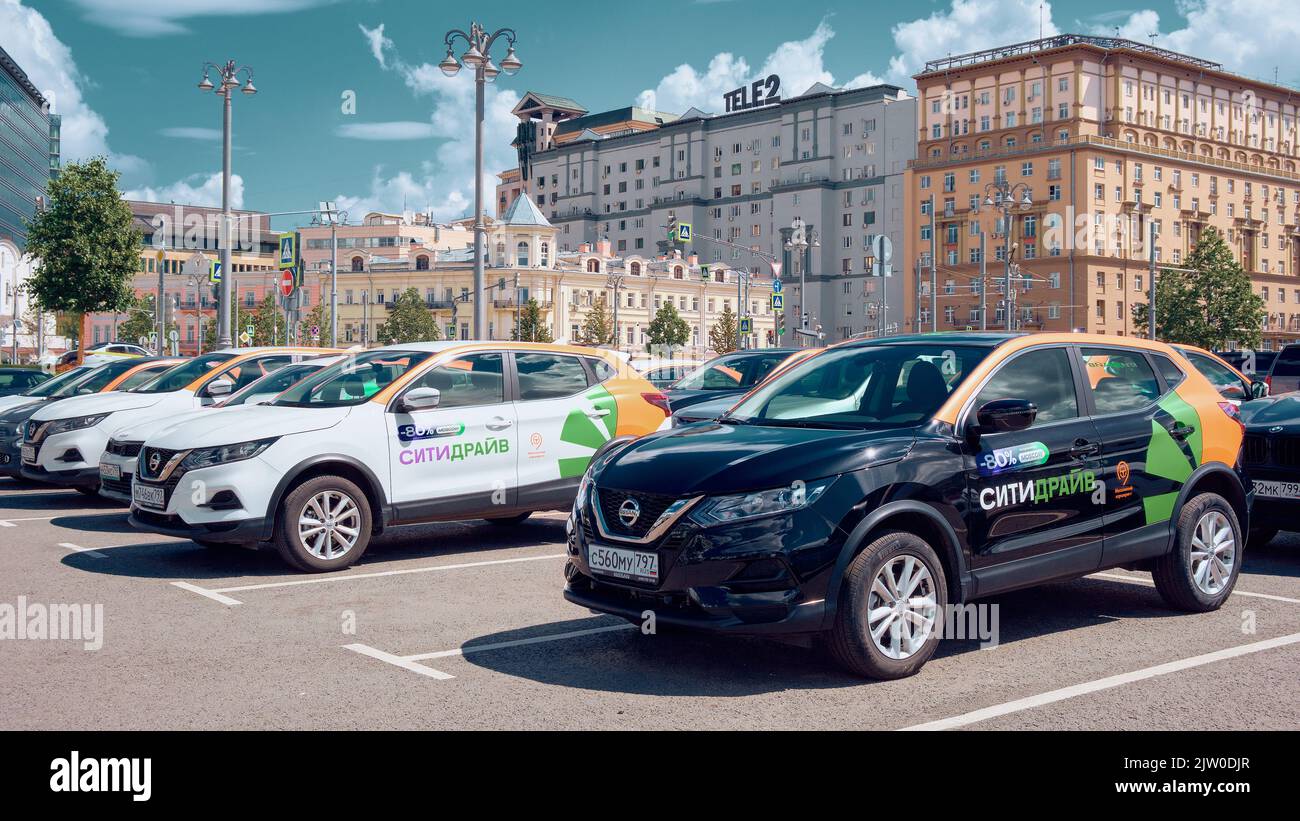 Carshare cars at the Tverskaya Zastava Square parking lot against a backdrop of urban architecture: Moscow, Russia - July 22, 2022 Stock Photo