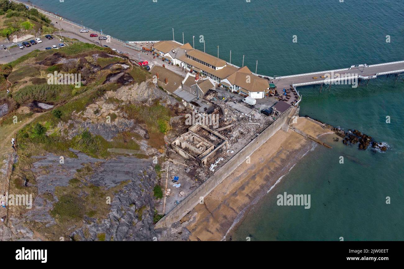 Swansea, UK. 02nd Sep, 2022. Workers clearing up in the remains of the former Cinderella's nightclub today alongside the lighthouse and Pier in the small village of Mumbles, Swansea, UK. The former nightclub was destroyed by a large fire earlier this week Credit: Phil Rees/Alamy Live News Stock Photo