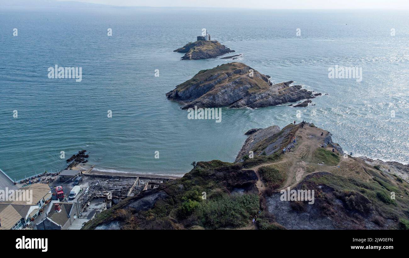 Swansea, UK. 02nd Sep, 2022. Workers clearing up in the remains of the former Cinderella's nightclub today alongside the lighthouse and Pier in the small village of Mumbles, Swansea, UK. The former nightclub was destroyed by a large fire earlier this week Credit: Phil Rees/Alamy Live News Stock Photo