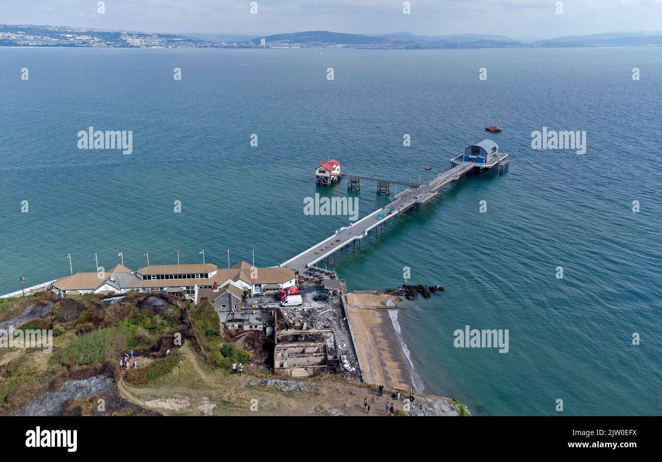 Swansea, UK. 02nd Sep, 2022. Workers clearing up in the remains of the former Cinderella's nightclub today alongside the lighthouse and Pier in the small village of Mumbles, Swansea, UK. The former nightclub was destroyed by a large fire earlier this week Credit: Phil Rees/Alamy Live News Stock Photo