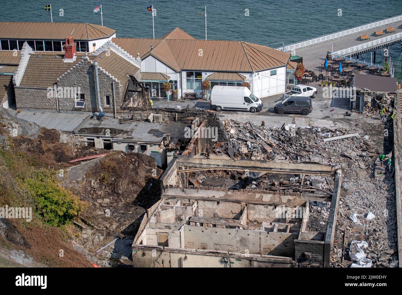 Swansea, UK. 02nd Sep, 2022. Workers clearing up in the remains of the former Cinderella's nightclub today alongside the lighthouse and Pier in the small village of Mumbles, Swansea, UK. The former nightclub was destroyed by a large fire earlier this week Credit: Phil Rees/Alamy Live News Stock Photo