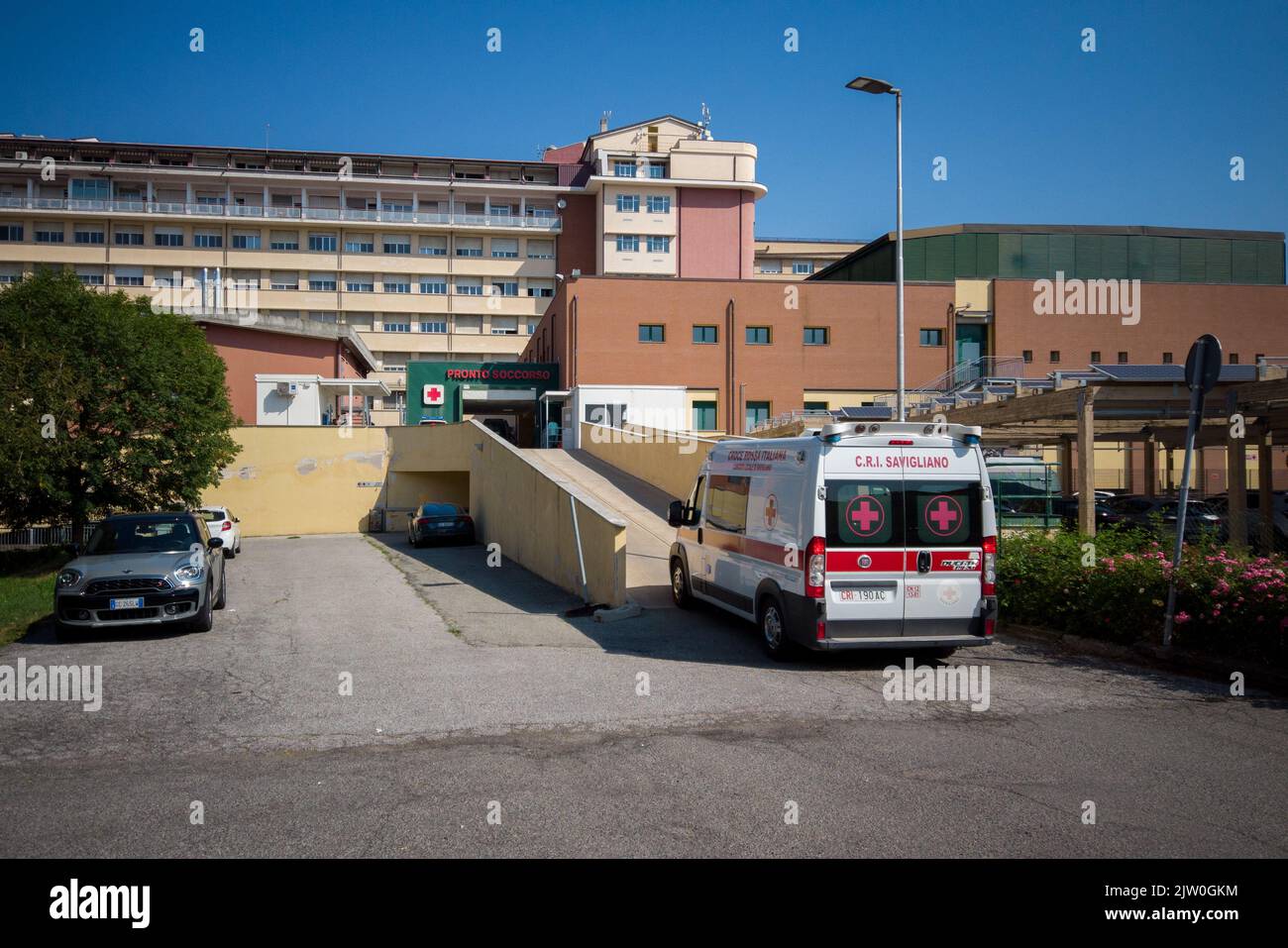 Savigliano, Cuneo, Italy - August 09, 2022: ambulance of the Red Cross of Savigliano that climbs the ramp towards the emergency room of the SS Annunzi Stock Photo
