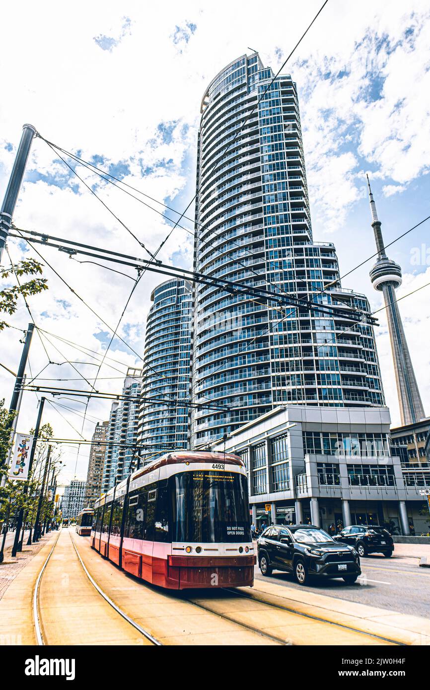 Toronto transit red streetcar, in the background it's possible to see the CN Tower. Stock Photo