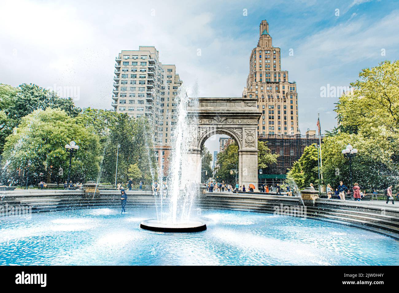 View of the Washington Square Arch and the One Fifth Avenue Apartment building from inside the Washington Square Park, Manhattan, New York City. Stock Photo