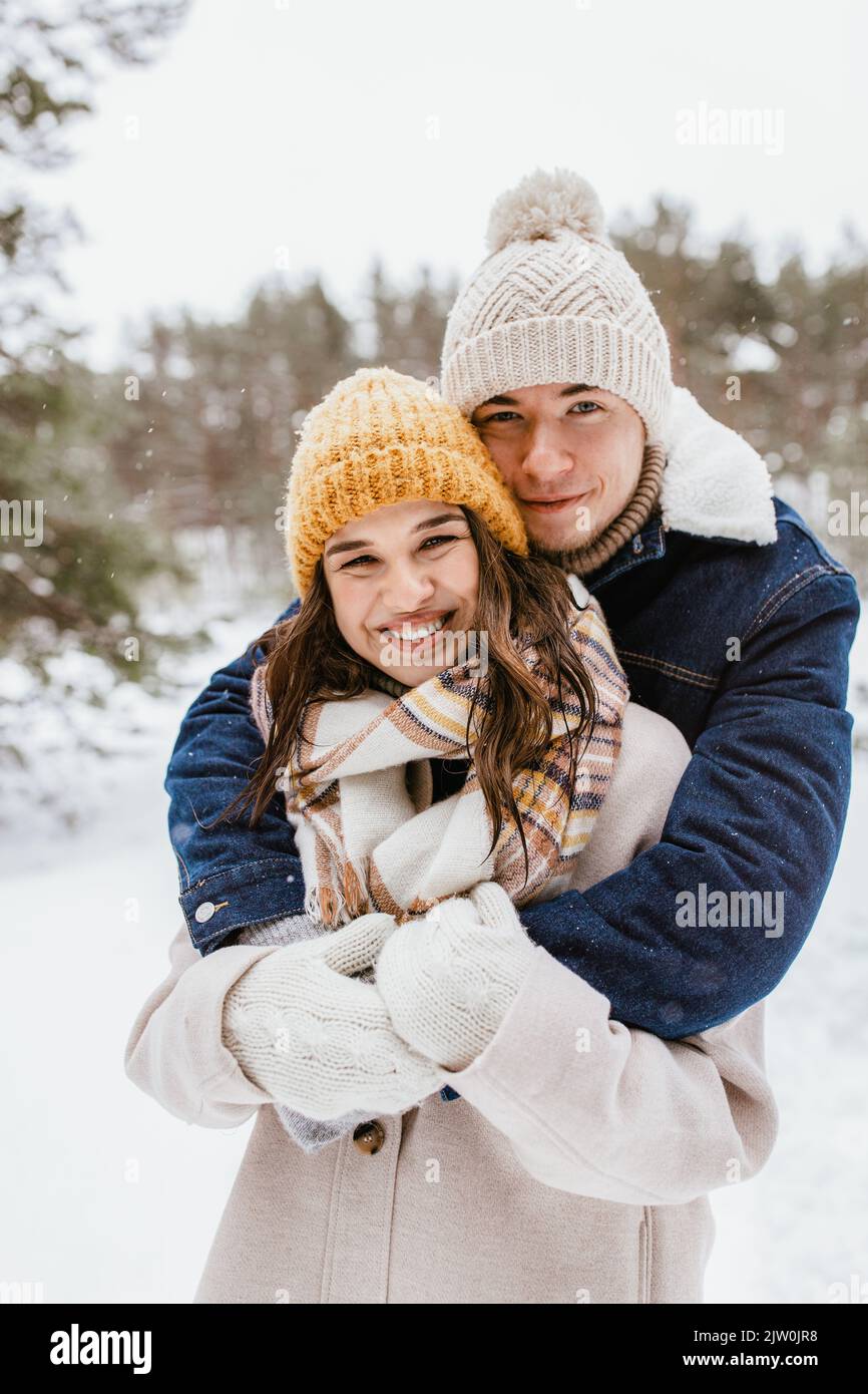 happy smiling couple hugging in winter park Stock Photo - Alamy