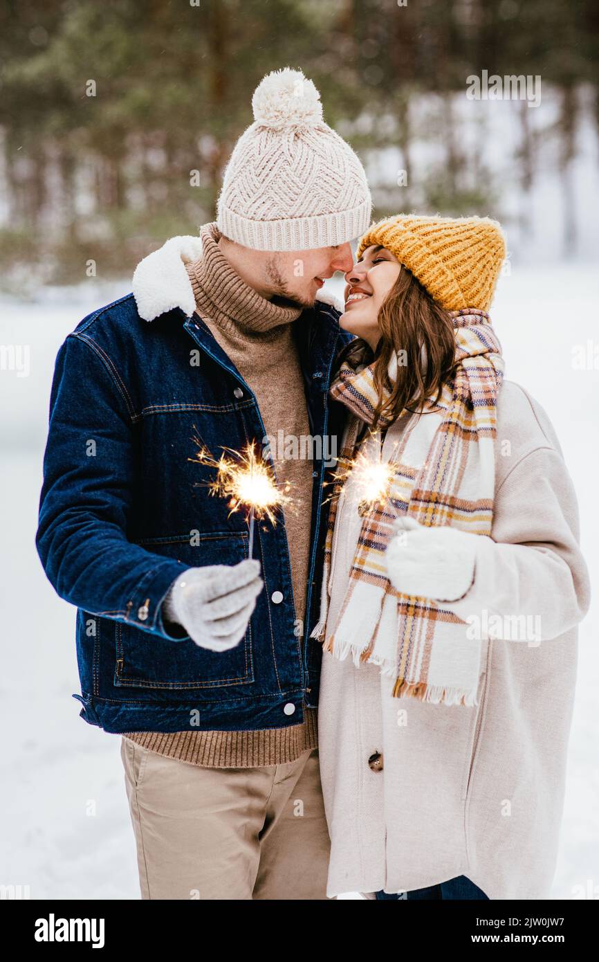 Happy couple in the snowy forest hi-res stock photography and images ...