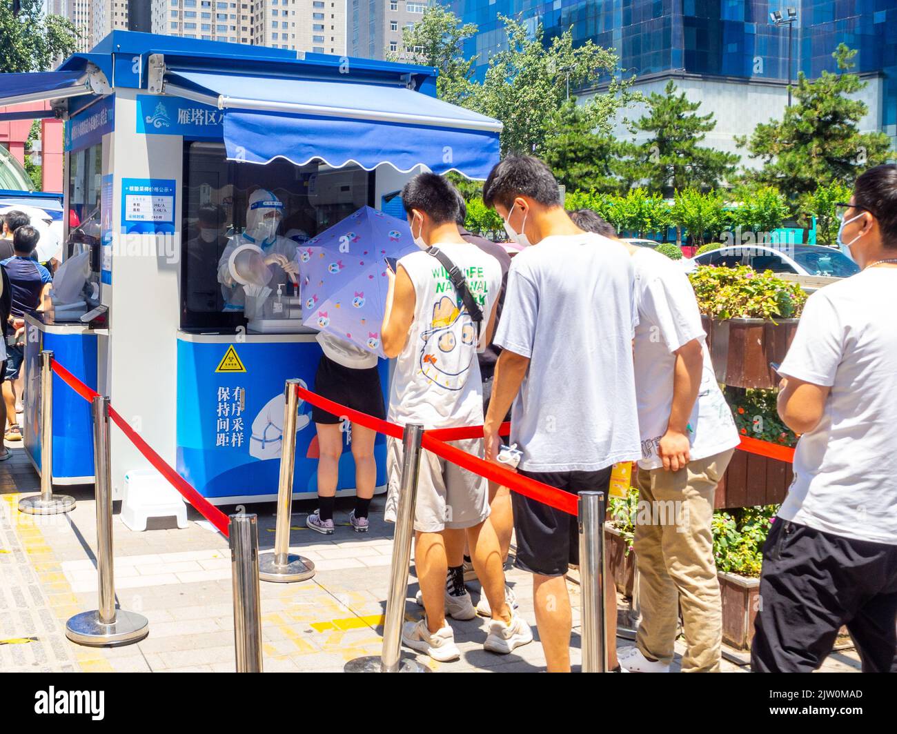 Chinese people lining up to get a Covid-19 test in the downtown district. Stock Photo