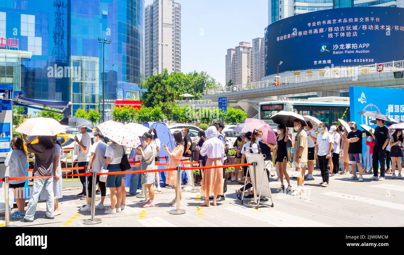 Chinese people lining up to get a Covid-19 test in the downtown district. Stock Photo