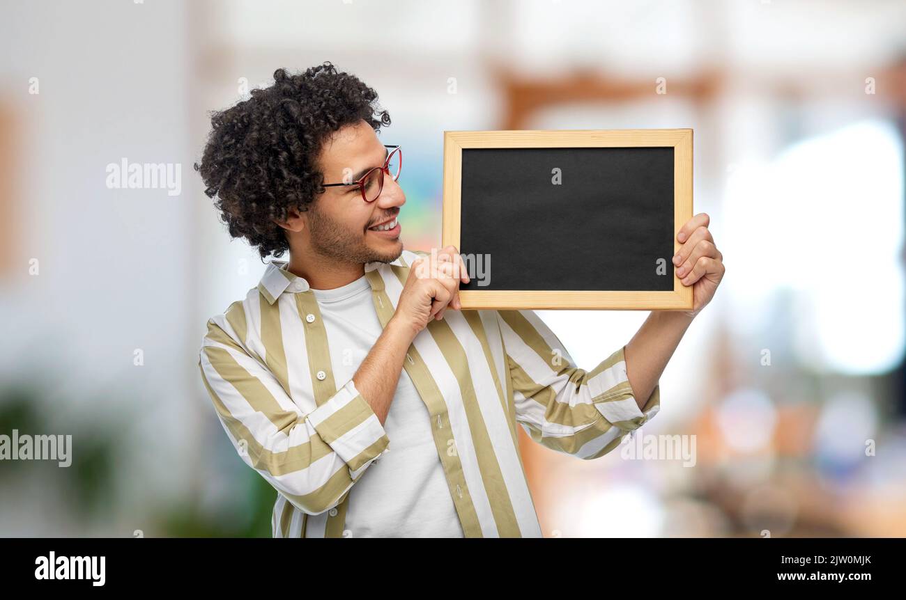 smiling man with chalkboard at office Stock Photo